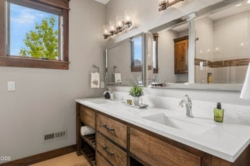 Third ensuite has dual vanities again and tiled walk-in shower with glass doors