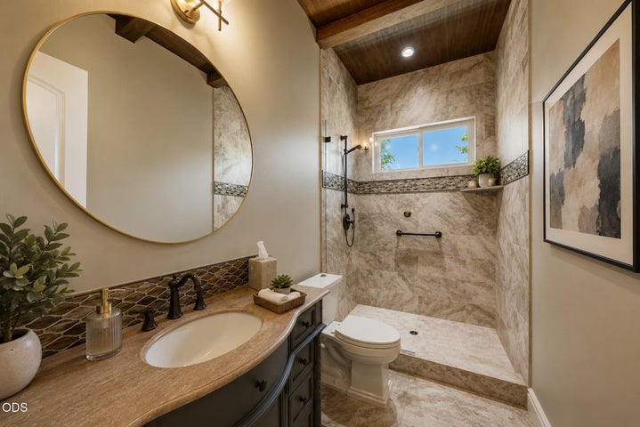 Mainlevel full bath located between guest room and office. Lovely wood beam ceiling